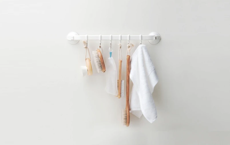 a bunch of toothbrushes hanging on a wall, by Shitao, minimalism, official product image, hook as ring, versatile, 5 7 9