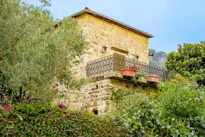 a building with a balcony in the middle of a garden, a portrait, by Bernardo Daddi, shutterstock, traditional corsican, stock photo, portrait of a old, with highly detailed