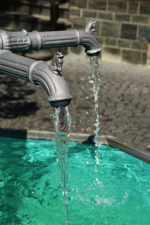 a close up of a faucet with water coming out of it, by Cherryl Fountain, shutterstock, renaissance, drainpipes, swimmingpool, 7 0 mm photo