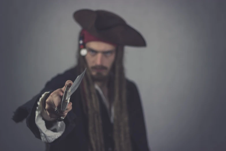 a man in a pirate costume holding a pair of scissors, a portrait, renaissance, pov photo, cinematic outfit photo