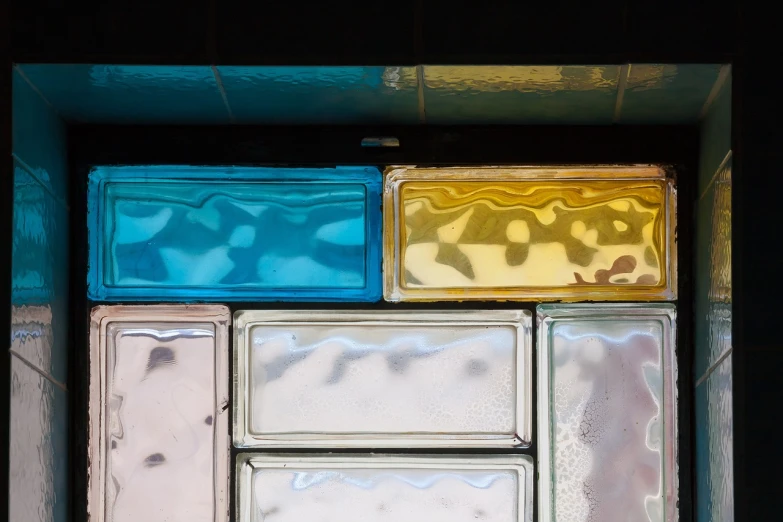 a bunch of glass blocks stacked on top of each other, a mosaic, inspired by Mondrian, unsplash, window. netherlands tavern, pastel colorful mold, sao paulo, shot on sony a 7
