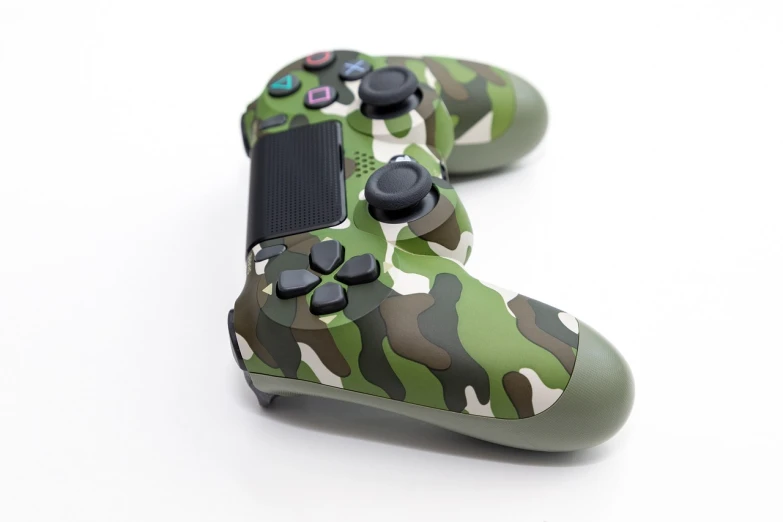 a couple of video game controllers sitting next to each other, a picture, jungle camo, on white background, close up angle, playstation 4