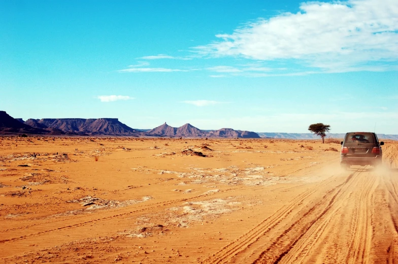 a truck driving down a dirt road in the desert, a picture, shutterstock, hurufiyya, beautiful iphone wallpaper, landscape of africa, very wide wide shot, background image