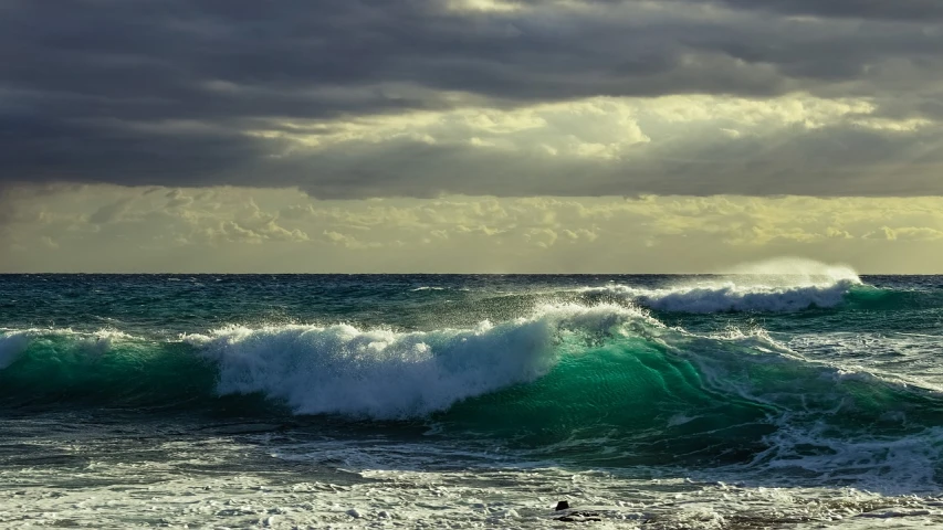 a person riding a surfboard on a wave in the ocean, a picture, by Alexander Bogen, paul barson, glistening seafoam, charybdis, shoreline