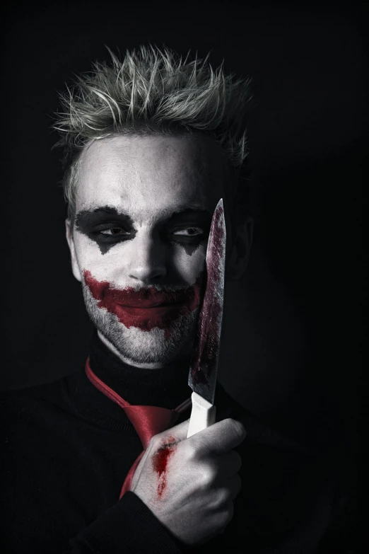 a man dressed as the joker holding a knife, a portrait, shutterstock, one man is blond, slit - scan photography, [[blood]], hyperealistic photo