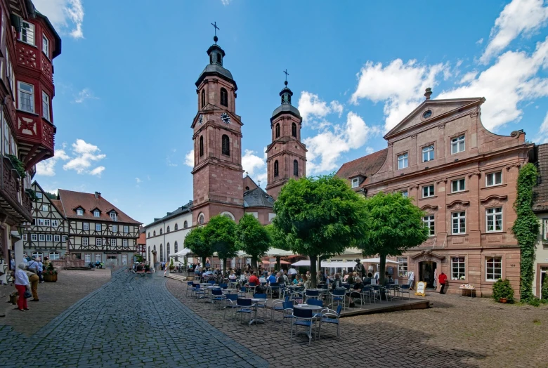 a cobblestone street lined with tables and chairs, a photo, by Juergen von Huendeberg, shutterstock, church in the background, bizzaro, cherry, panorama shot