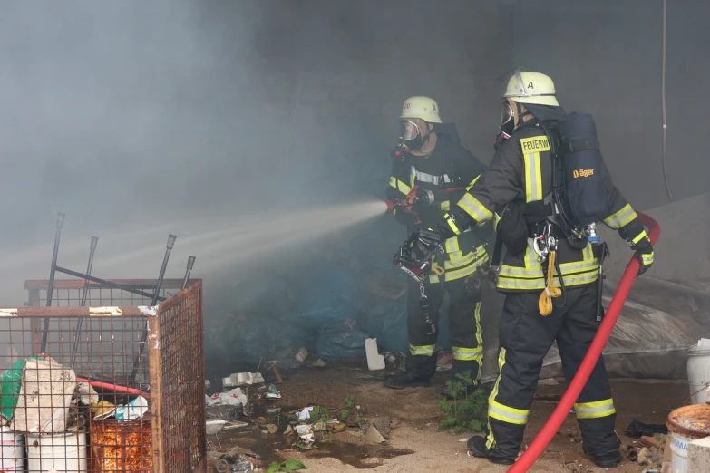 a group of firefighters standing next to each other, a picture, by Caroline Mytinger, shutterstock, garbage, smoke filled room, berlin, footage