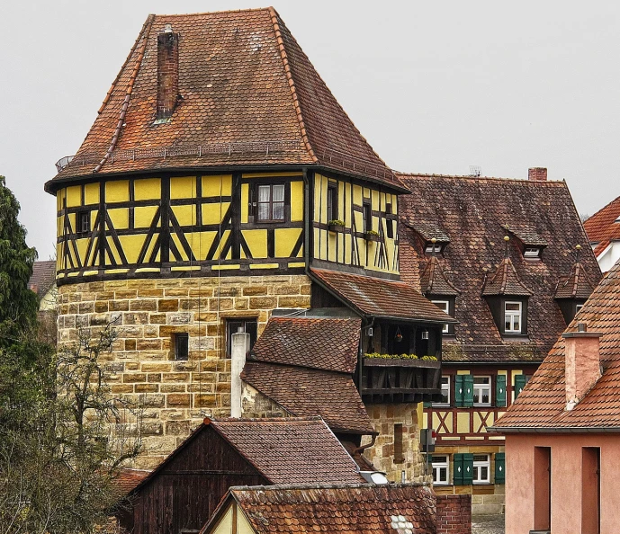 a tall tower with a clock on top of it, a photo, by Karl Hagedorn, shutterstock, medieval tavern, with yellow cloths, peaked wooden roofs, oversaturated