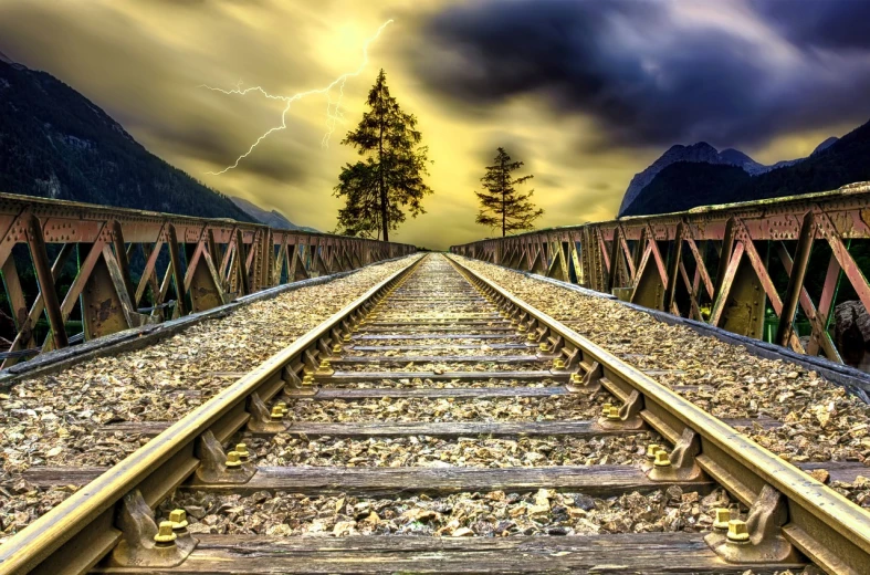 a train track with a lightning bolt in the background, a picture, trending on pixabay, fantastic realism, wooden bridge, yellow flash, distant mountains lights photo, hdr photo