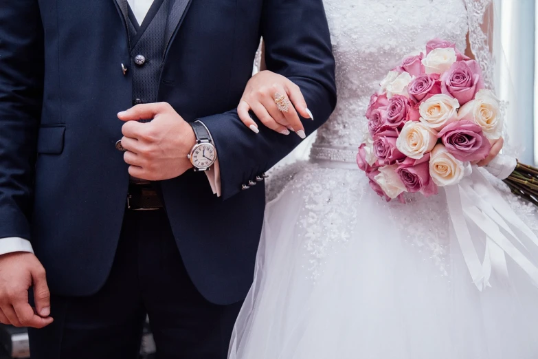 a man in a tuxedo and a woman in a wedding dress, by Maksimilijan Vanka, pexels, holding arms on holsters, 🌸 🌼 💮, divine details, elaborate jewelry