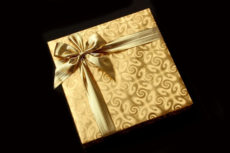 a gift wrapped in gold paper with a bow, by Kanō Tan'yū, pixabay, baroque, embossed, 1 6 x 1 6, gourmet, 7 7 7 7