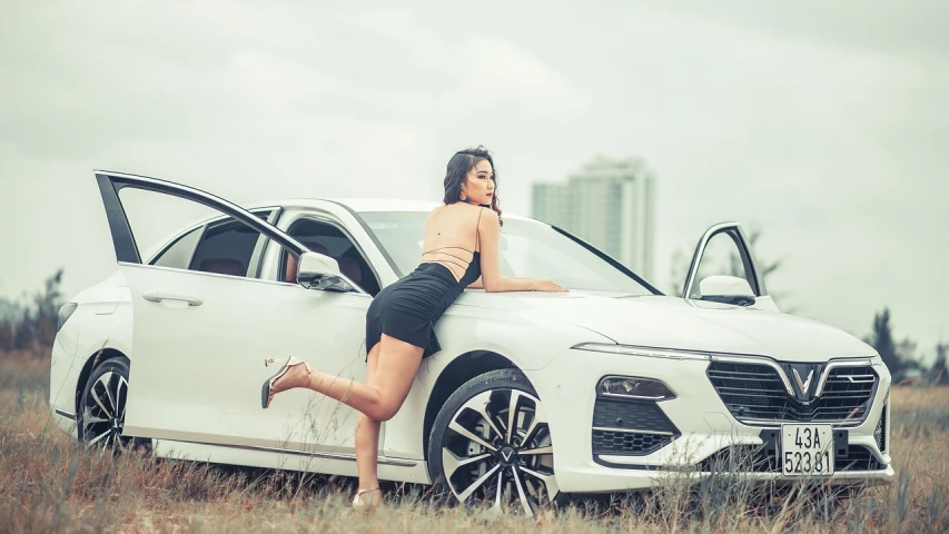 a woman leaning on the hood of a white car, inspired by Hedi Xandt, trending on cg society, gorgeous chinese model, good hips and long legs, marketing photo, postprocessed