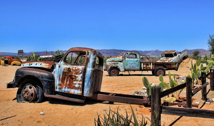 a couple of trucks that are sitting in the dirt, by Arnie Swekel, flickr, auto-destructive art, hollister ranch, background image, patchy cactus, old furnitures