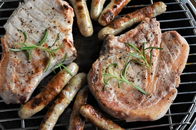 a close up of meat and sausages on a grill, by Dietmar Damerau, pixabay, dau-al-set, lamb and goat fused as one, istockphoto, food styling, stems