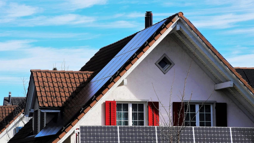 a house with a solar panel on the roof, by Carey Morris, shutterstock, red roofs, highly contrasted elements, bottom shot, très détaillé