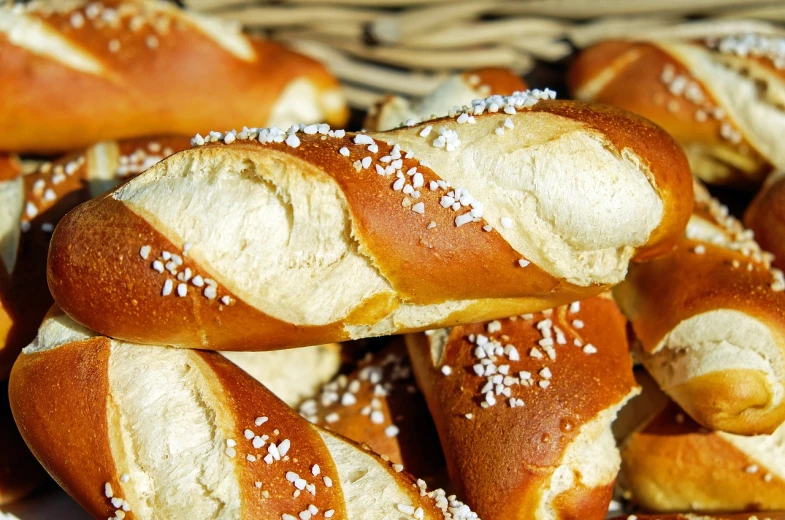 a pile of pretzels sitting on top of each other, by Franz Hegi, pixabay, baroque, baking french baguette, sexy sesame seed buns, detailed picture, golden eal