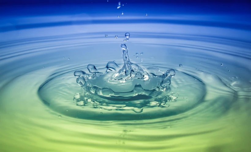 a water drop falling into a body of water, a picture, shutterstock, renaissance, some yellow green and blue, stock photo