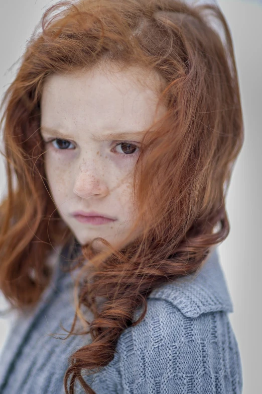 a close up of a young girl with freckled hair, long ginger hair windy, sad!, aubrey powell, young child