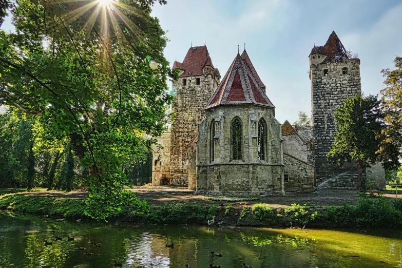 a church sitting next to a body of water, a photo, by Koloman Sokol, romanesque, ancient ruins in the forest, the sun is shining. photographic, turrets, in a city with a rich history