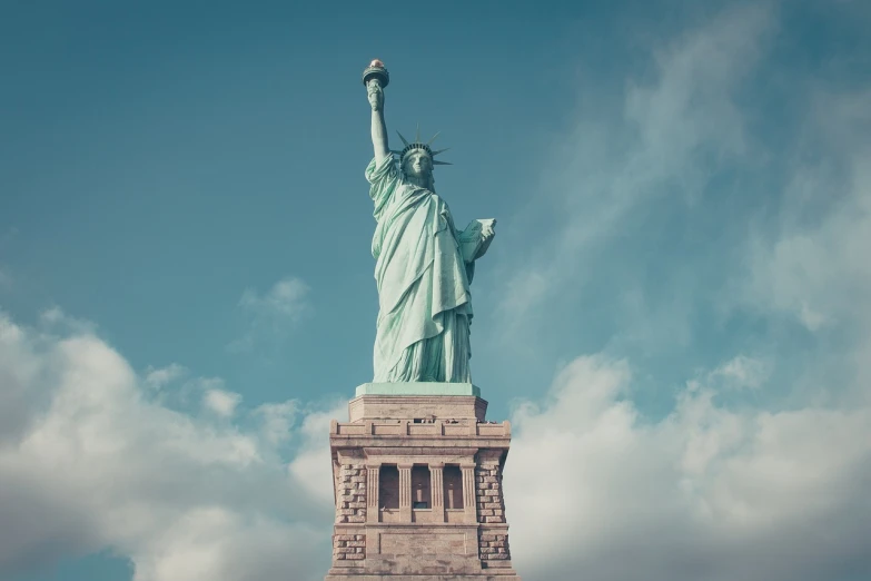 a statue of liberty on a cloudy day, a statue, by Joseph Werner, shutterstock, art nouveau, 24mm tilt-shift, retro stylised, americana architecture, 2000s photo