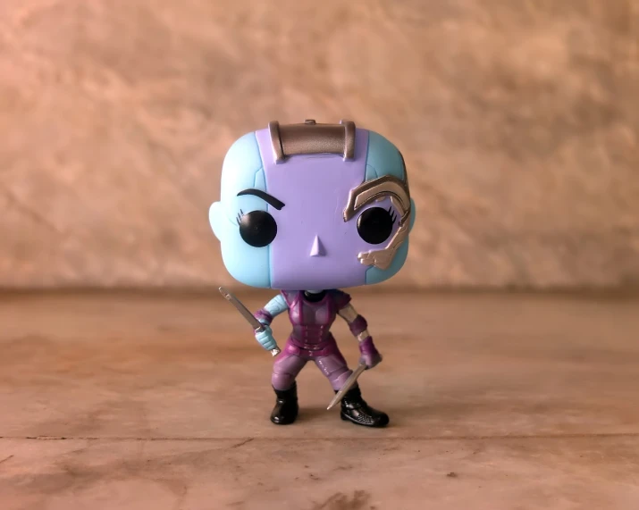 a close up of a toy on a table, a character portrait, inspired by Chip Zdarsky, pexels, nebula highly detailed, she is ready to fight, as a full body funko pop!, post processed denoised