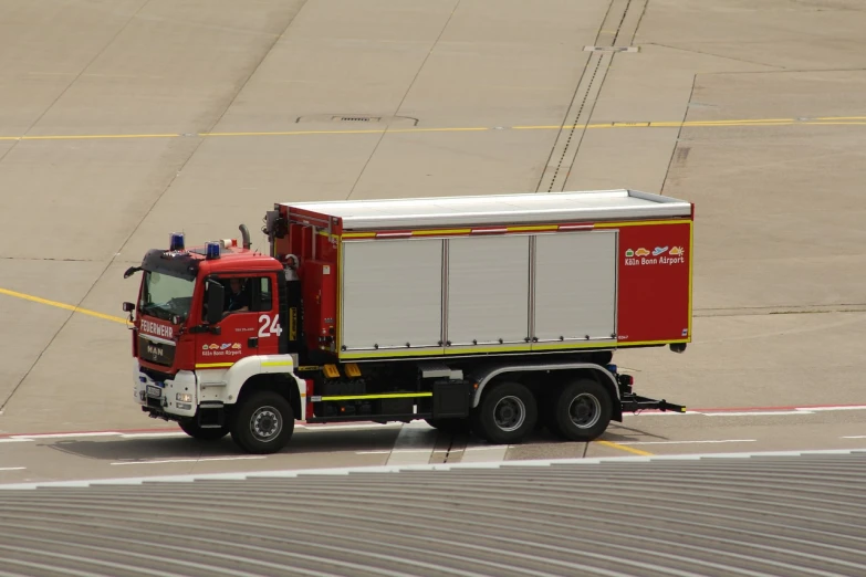 a red and white truck sitting on top of an airport tarmac, a picture, by Hans Schwarz, firefighting gear, black and yellow and red scheme, tgv, jean - baptiste belin