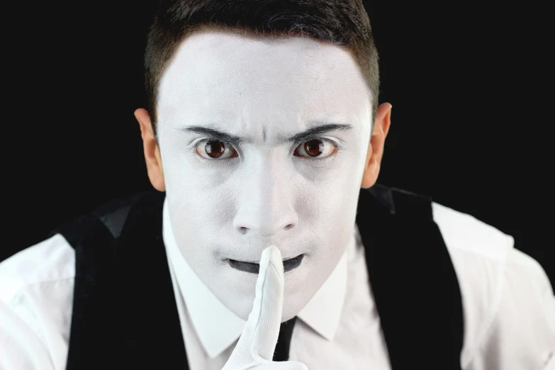 a man dressed as a mime with a banana in his mouth, a portrait, inspired by Bálint Kiss, shutterstock, white suit and black tie, silence, face photo, professional closeup photo