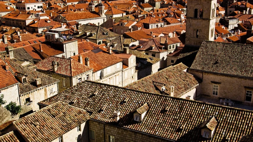 an aerial view of a city with a clock tower, baroque, roofing tiles texture, dubrovnik, great light and shadows”