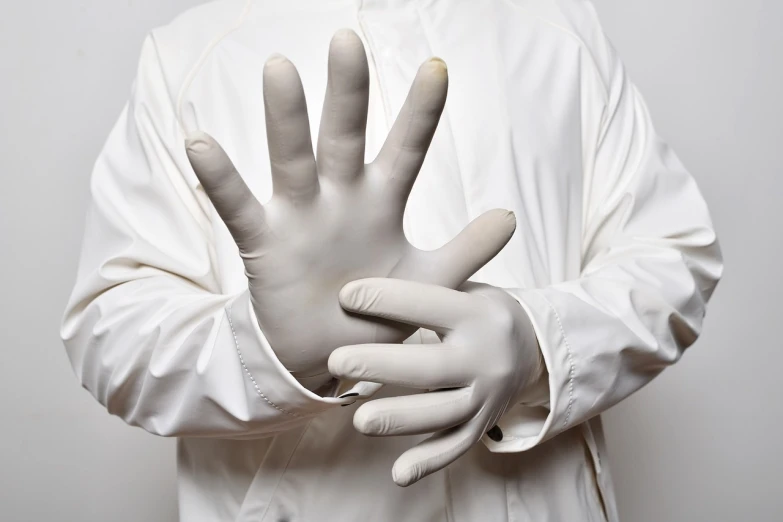 a close up of a person wearing gloves, a stock photo, by Elizabeth Charleston, shutterstock, plasticien, lab coat and tee shirt, grey rubber undersuit, 5 fingers). full body, ivory