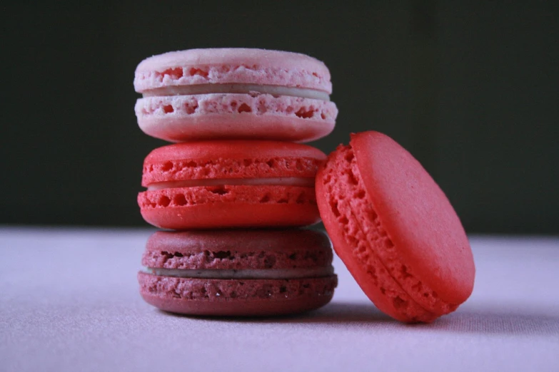 a stack of macarons sitting on top of each other, inspired by François Bocion, flickr, pink and red color scheme, ultrafine detail ”, deep colour\'s, four