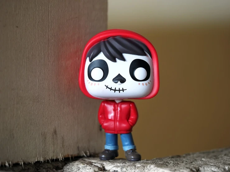 a close up of a figurine of a person wearing a red hoodie, a picture, pixabay, lowbrow, el dia los muertos!, funko pop”, teen boy, high res photo