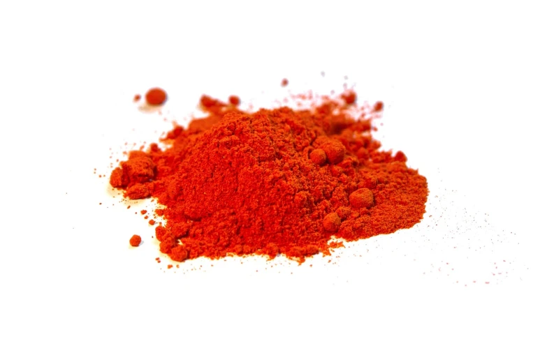 a pile of red powder on a white surface, a pastel, by Juan O'Gorman, hurufiyya, vibrant orange, highly detailed product photo, titanium, devils