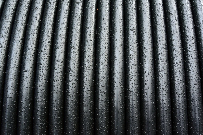 a close up of a hose with water droplets on it, inspired by Pierre Soulages, minimalism, beautiful high detail photo, modern high sharpness photo, 33mm photo, rounded roof