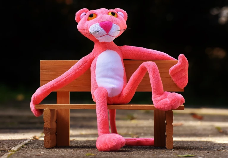 a pink stuffed animal sitting on top of a wooden bench, a picture, inspired by Leo Leuppi, pexels, realism, tony the tiger, fully posable, based on a puma, high res photo