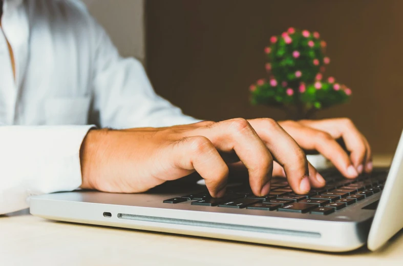 a close up of a person typing on a laptop, a stock photo, pexels, very detailed background, a handsome, half image, low