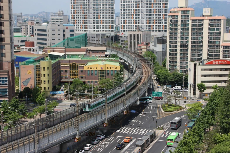 a large long train on a steel track, by Yi Jaegwan, flickr, the neat and dense buildings, serpentine curve!!!, sangsoo jeong, hi-res photo