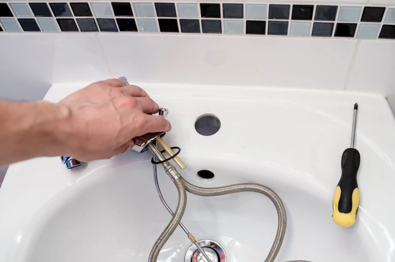 a person fixing a sink in a bathroom, a stock photo, by Joe Bowler, shutterstock, corrugated hose, detailed detailed detailed, square, low resolution