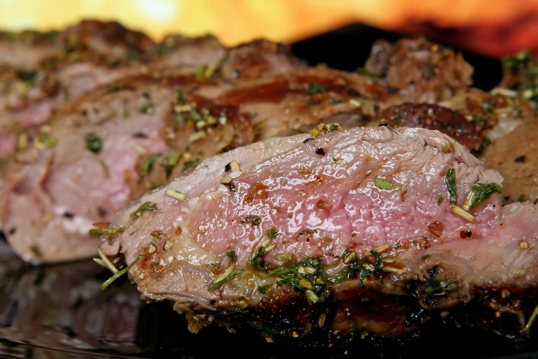 a close up of some meat on a plate, by Jakob Gauermann, pixabay, molten, herbs, side view close up of a gaunt, rack
