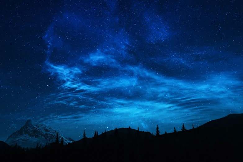 a night sky with a mountain in the background, blue cloudy sky, luminescent wisps, glistening clouds in background, forest at night