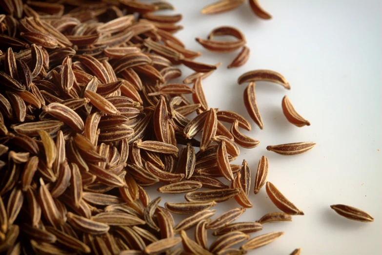 a pile of seeds sitting on top of a table, a macro photograph, hurufiyya, close-up product photo, valerian, highly detailed product photo, camel