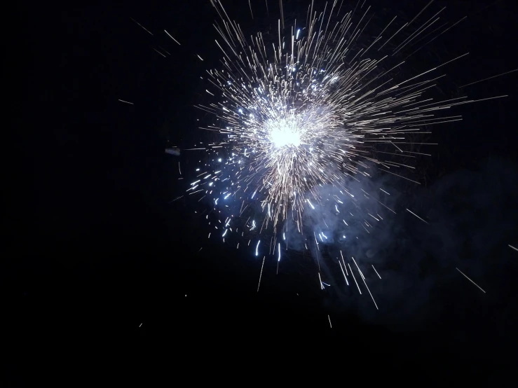 a close up of a fireworks in the night sky, a picture, by Erwin Bowien, hurufiyya, 4 k ], wikimedia, shot from a low angle, taken on a 2010s camera