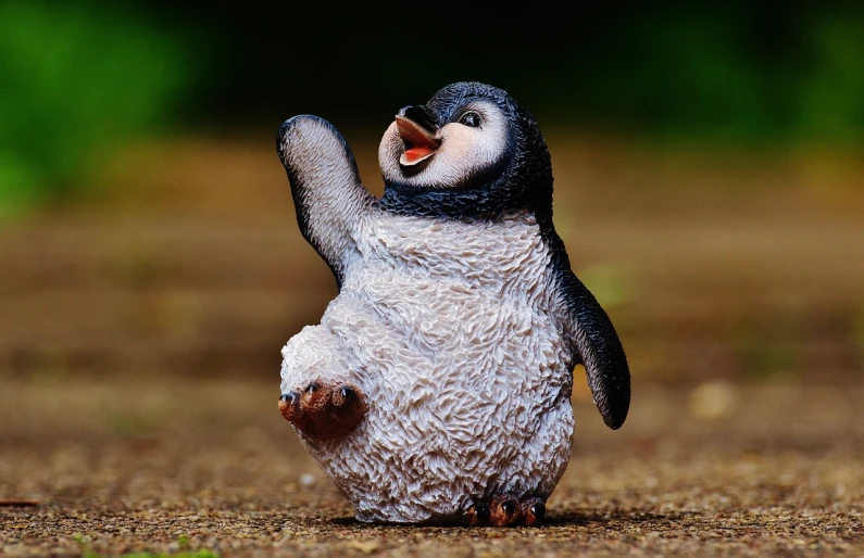 a close up of a toy penguin on a dirt ground, a picture, figuration libre, dancing character, highly detailed product photo, 🦩🪐🐞👩🏻🦳, adorable appearance!!!