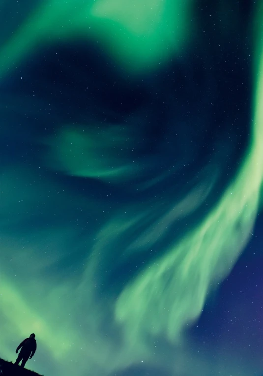 a man standing on top of a snow covered slope, a picture, by Ejnar Nielsen, hurufiyya, northern lights in space, banner, close up photo, beautiful lighting uhd