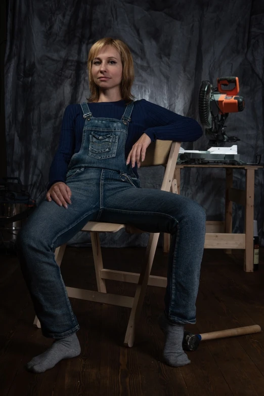 a woman sitting on top of a wooden chair, featured on reddit, photorealism, wearing overalls, professional studio photo, chainsaw man, full frontal shot