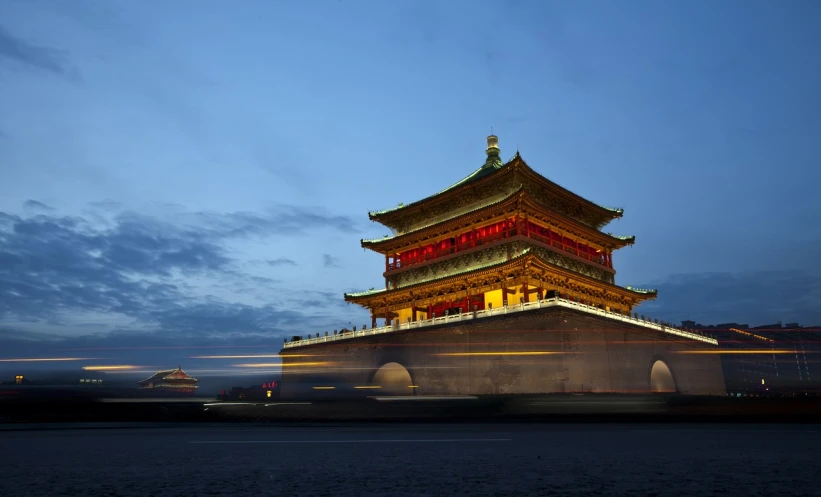 a very tall building with a lot of lights on it, a picture, inspired by Yang Buzhi, tiananmen square, golden and blue hour, monolithic temple, traveling through time