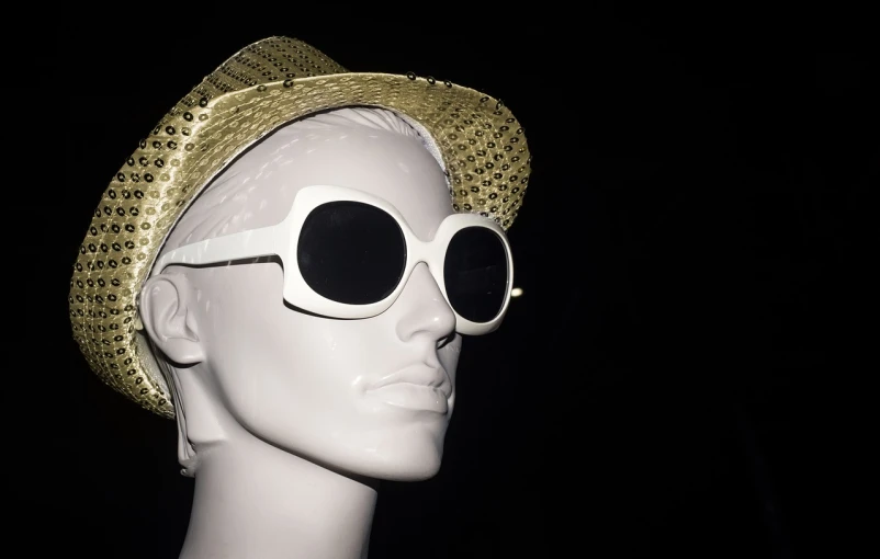 a mannequin wearing a straw hat and sunglasses, inspired by Bert Stern, pop art, white with gold accents, nigth, close - up studio photo, crown of (((white lasers)))