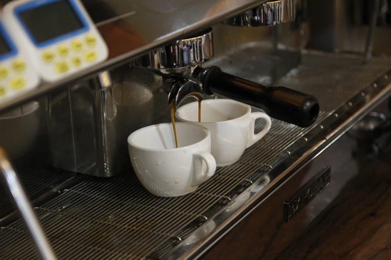 two cups of coffee being poured into a coffee machine, by Yasushi Sugiyama, flickr, bottom angle, italian, afp, closeup photo