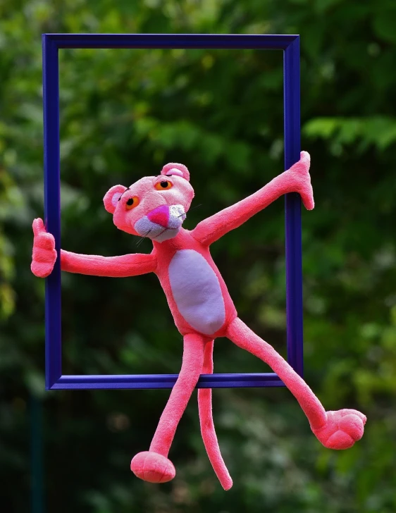 a pink stuffed animal hanging from a blue frame, by Jan Rustem, flickr, tony the tiger, stopmotion animation, having fun in the sun, alexey gurylev