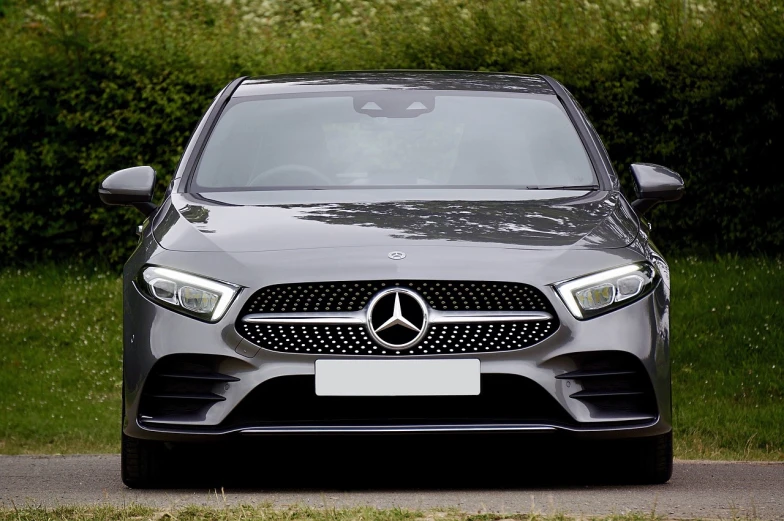 a mercedes car parked on the side of the road, by Alexander Brook, pexels, front face asymmetrical, gun metal grey, rectangle, full front view