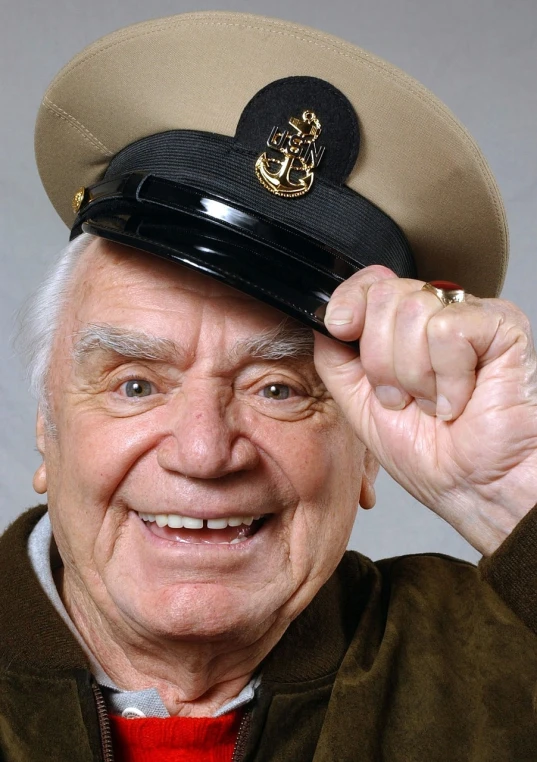 a close up of a person wearing a hat, by Arnie Swekel, american veteran gi, bearing a large mad grin, jean girard, raising an arm